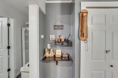 a hallway with a shelf next to a door at Waterfront Wallkill Duplex Home with Fire Pits! in Wallkill