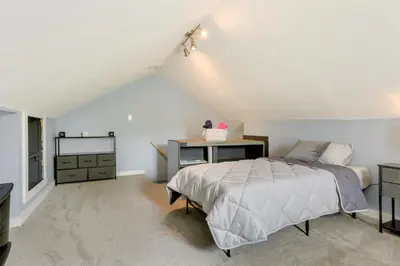 a attic bedroom with a bed and a desk at Waterfront Wallkill Duplex Home with Fire Pits! in Wallkill