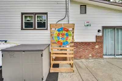 a house with a ladder and a sign next to it at Waterfront Wallkill Duplex Home with Fire Pits! in Wallkill