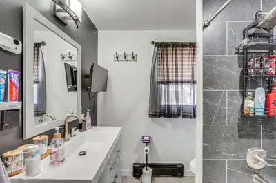 a bathroom with a sink and a shower at Waterfront Wallkill Duplex Home with Fire Pits! in Wallkill