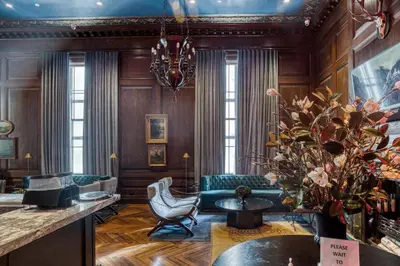 a living room with wooden walls and a chandelier at FiDi Studio w Residents Bar Golf Simulator Gym NYC-271 in New York