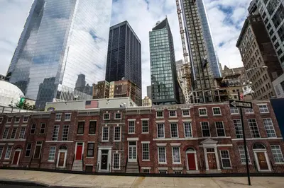 a red brick building in a city with tall buildings at FiDi Studio w Residents Bar Golf Simulator Gym NYC-271 in New York
