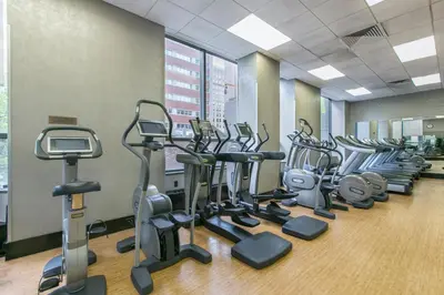 a row of cardio machines in a gym at Tribeca Studio w Tons of light Gym Pool NYC-118 in New York