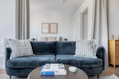a blue couch in a living room with a coffee table at Tribeca Studio w Tons of light Gym Pool NYC-118 in New York