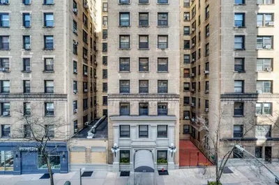 a view of a building in front of tall buildings at UWS 1br w gym doorman nr Central Park NYC-1100 in New York