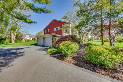 a driveway in front of a red house at 10 Mi to Dtwn Lancaster Charming Home with Yard! in Leola
