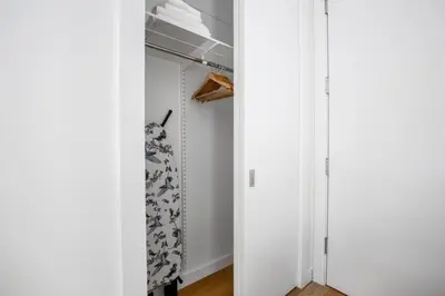 a room with a closet with white walls and a curtain at SoHo 1br w outdoor space in-unit wd NYC-1143 in New York