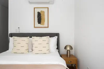 a bed with white sheets and pillows in a bedroom at SoHo 1br w outdoor space in-unit wd NYC-1143 in New York