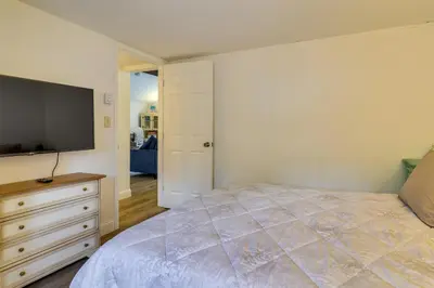 a bedroom with a bed and a flat screen tv at Fire Pit and Deck Inviting Pocono Lake Home in Pocono Lake