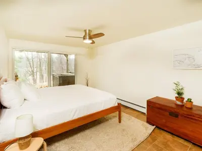 a white bedroom with a bed and a window at Catskills Escape - Serenity on 105 Acres, 2 hours from NYC in Ellenville