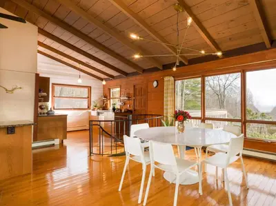 a kitchen and dining room with a table and chairs at Catskills Escape - Serenity on 105 Acres, 2 hours from NYC in Ellenville