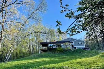 a house on top of a hill with trees at Catskills Escape - Serenity on 105 Acres, 2 hours from NYC in Ellenville