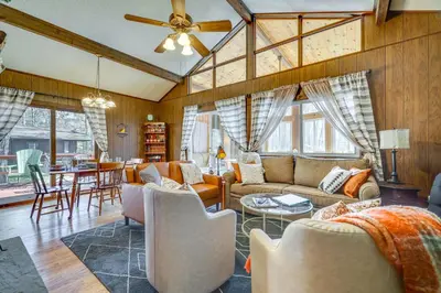 a living room with a couch and chairs and a table at Cozy Pocono Lake Cottage with Fire Pit and Ping Pong! in Pocono Lake