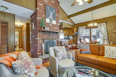 a living room with a couch and a fireplace at Cozy Pocono Lake Cottage with Fire Pit and Ping Pong! in Pocono Lake