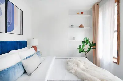 a white living room with a blue and white couch at 48-3RW Brand New 1BR Prime Hells Kitchen - W D in New York