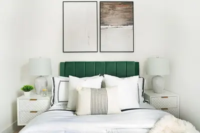 a bedroom with a green and white bed with two lamps at 48-5FE Brand New 2BR in prime Midtown in New York