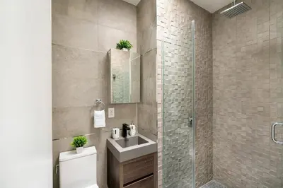 a bathroom with a toilet and a sink and a shower at 48-5FE Brand New 2BR in prime Midtown in New York