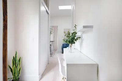 a room with white walls and a white counter with plants at 48-5FE Brand New 2BR in prime Midtown in New York