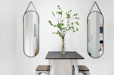 a table with two mirrors on a wall at 48-5FE Brand New 2BR in prime Midtown in New York