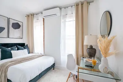 a bedroom with a bed and a table with a mirror at 48-5RW 1BR Apartment in Midtown West W D in New York