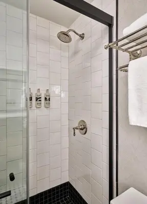 a bathroom with a shower with a glass door at Romer Hell's Kitchen in New York