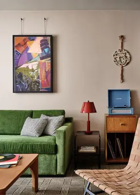 a living room with a green couch and a table at Romer Hell's Kitchen in New York