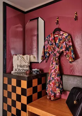 a coat hanging on a wall in a dressing room at Romer Hell's Kitchen in New York