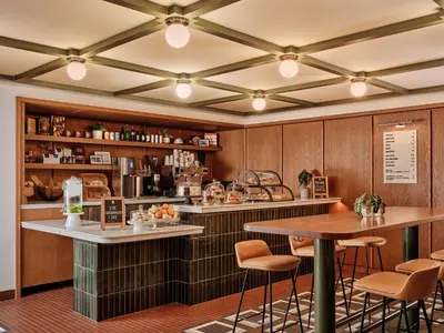 a bar with stools and tables in a restaurant at Romer Hell's Kitchen in New York