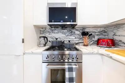 a kitchen with a stove and a tv on the counter at 13-3 I Brand New 4BR 3 Baths Duplex Private Roof Deck in New York