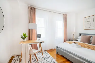 a bedroom with a bed and a desk and a window at 13-3 I Brand New 4BR 3 Baths Duplex Private Roof Deck in New York