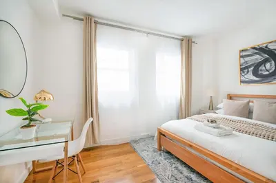 a bedroom with a bed and a desk and a mirror at 13-3 I Brand New 4BR 3 Baths Duplex Private Roof Deck in New York