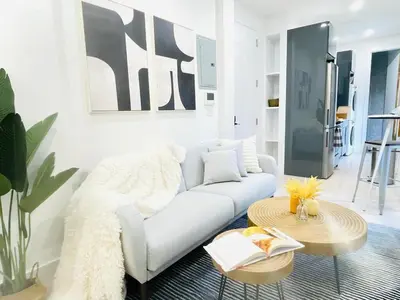 a living room with a white couch and a table at 48-1FE Brand New 1BR Prime hell's kitchen WD in unit in New York