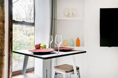 a table with two wine glasses and apples on it at 48-1FE Brand New 1BR Prime hell's kitchen WD in unit in New York