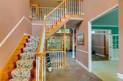 a staircase in a home with wooden railings at Lancaster Vacation Rental Near Dutch Wonderland! in Lancaster