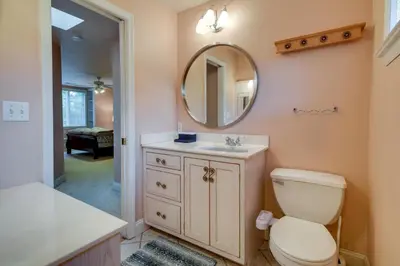 a bathroom with a toilet and a sink and a mirror at Lancaster Vacation Rental Near Dutch Wonderland! in Lancaster