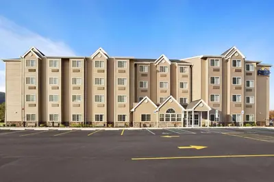 a large building with a parking lot in front of it at Microtel Inn & Suites-Sayre, PA in Sayre