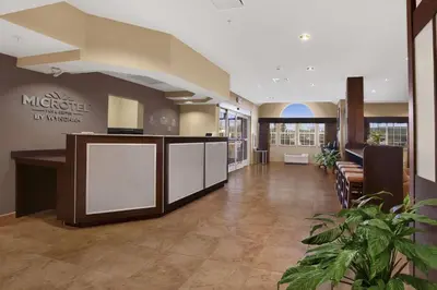 a lobby of a medical office with a counter and chairs at Microtel Inn & Suites-Sayre, PA in Sayre