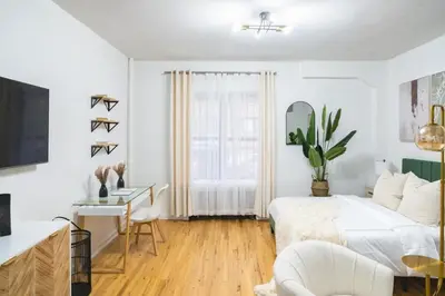 a white bedroom with a bed and a desk at 74-1A New Studio in Prime UWS - GYM In Building in New York