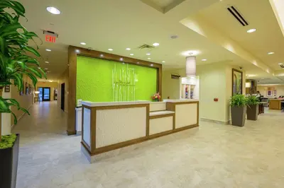 a lobby of a hospital with a green wall at Hilton Garden Inn Exton-West Chester in Exton