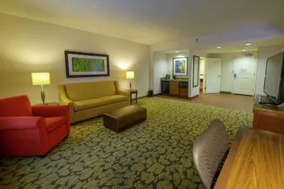 a large living room with a couch and a chair at Hilton Garden Inn Exton-West Chester in Exton