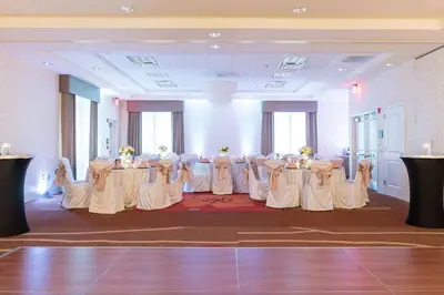 a set of tables in a room with white chairs at Hilton Garden Inn Exton-West Chester in Exton