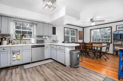a kitchen with white cabinets and a dining room at Breathtaking views. Hot tub. Huge Deck. Fast Wifi in Andes