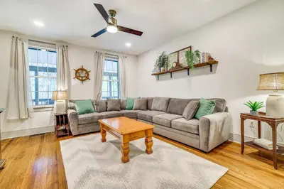 a living room with a couch and a table at Hot Tub and Lake Access at Poconos Getaway! in Lake Ariel