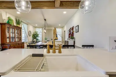 a kitchen and living room with a large white island at Hot Tub and Lake Access at Poconos Getaway! in Lake Ariel