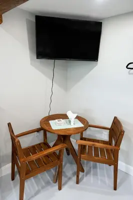 a table and two chairs with a television on a wall at Valley View Cabin in Morris