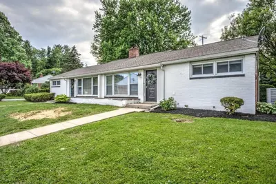 a white house with a grass yard at Renovated 2 BR home close to Lancaster attractions in Lancaster