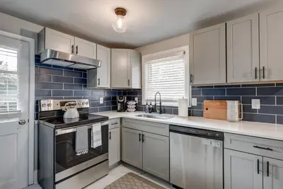 a kitchen with white cabinets and blue tiles at Renovated 2 BR home close to Lancaster attractions in Lancaster