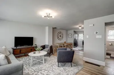 a living room with a couch and a tv at Renovated 2 BR home close to Lancaster attractions in Lancaster