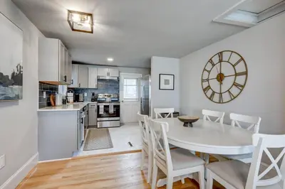 a kitchen and dining room with a white table and chairs at New cozy home near Outlets & Amish Country in Lancaster