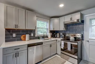 a kitchen with white cabinets and stainless steel appliances at New cozy home near Outlets & Amish Country in Lancaster